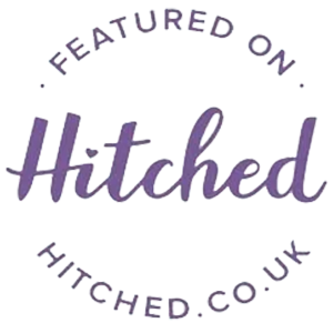 Circular badge with the text “Featured on Hitched” in purple script font, and “HITCHED.CO.UK” in uppercase letters along the bottom curve, perfect for showcasing Mosaic Wall designs or creative projects like Draw Me Bot.