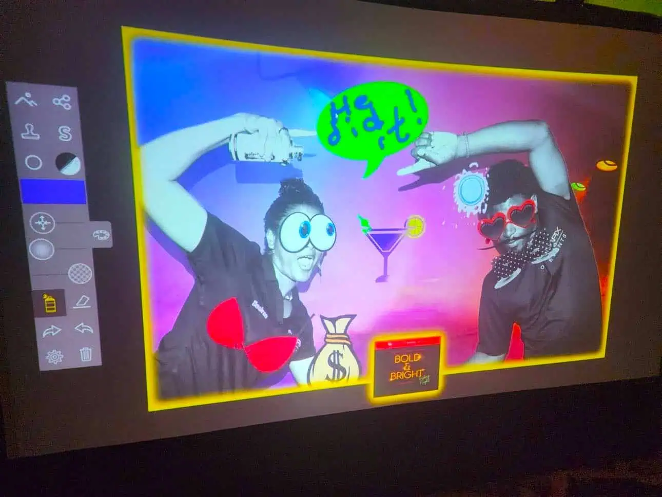 Guests posing with colourful digital artwork and playful graphic effects.