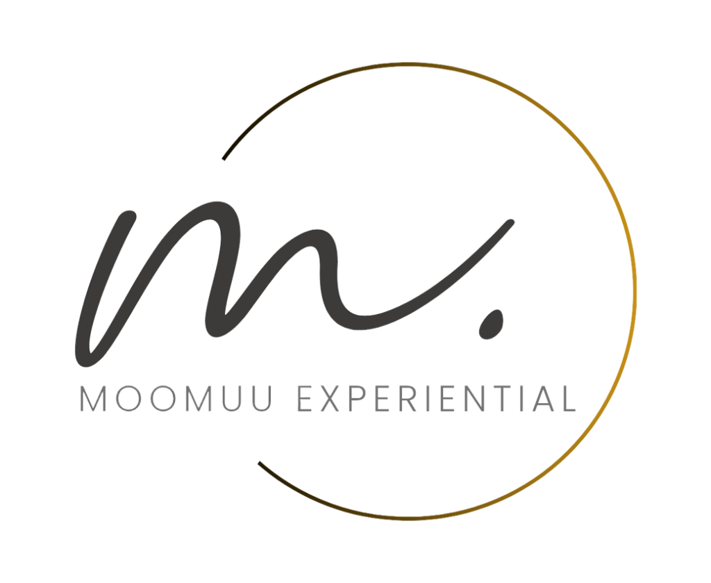 Logo for "MOOMUU EXPERIENTIAL" featuring a stylised "m." in black script, partially enclosed by a thin, gold semicircle on a light grey background.
