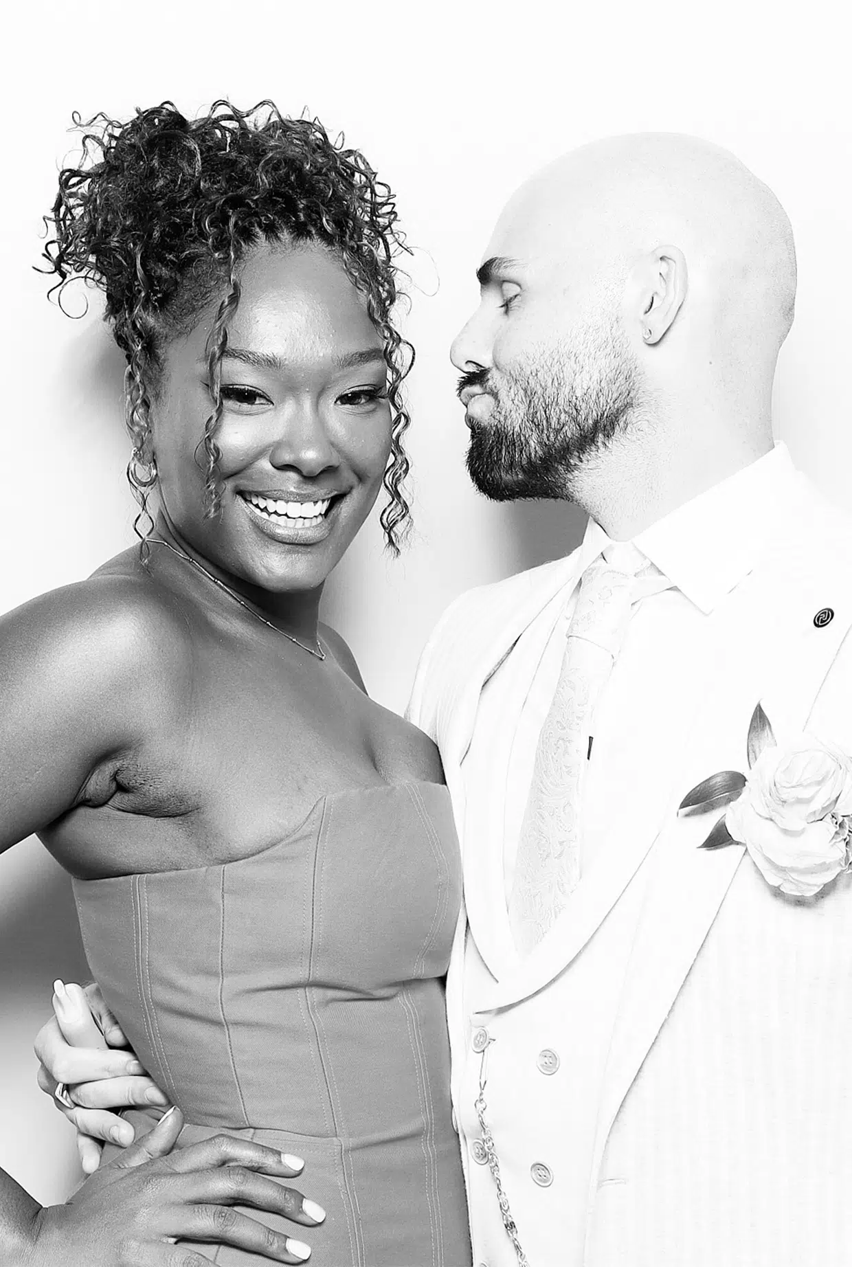 Wedding couple sharing a relaxed moment in a black-and-white Signature Glam Booth portrait.