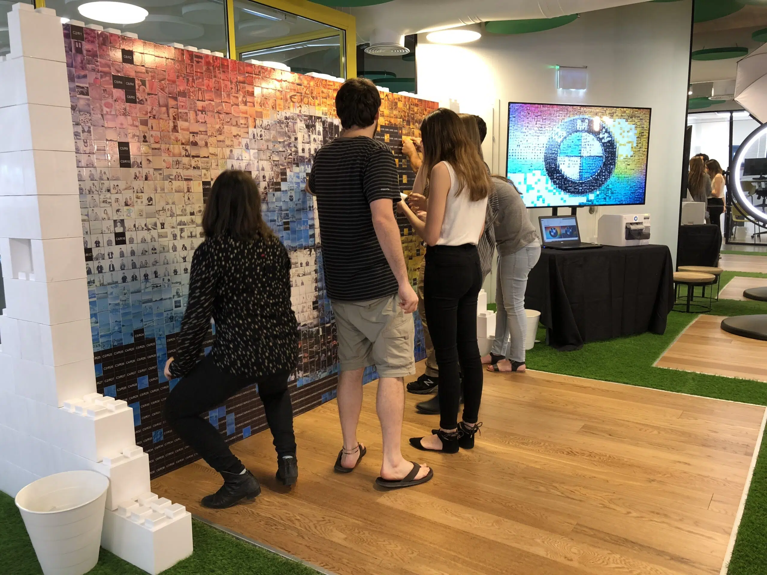 Guests adding photographs to a BMW Mosaic Wall activation