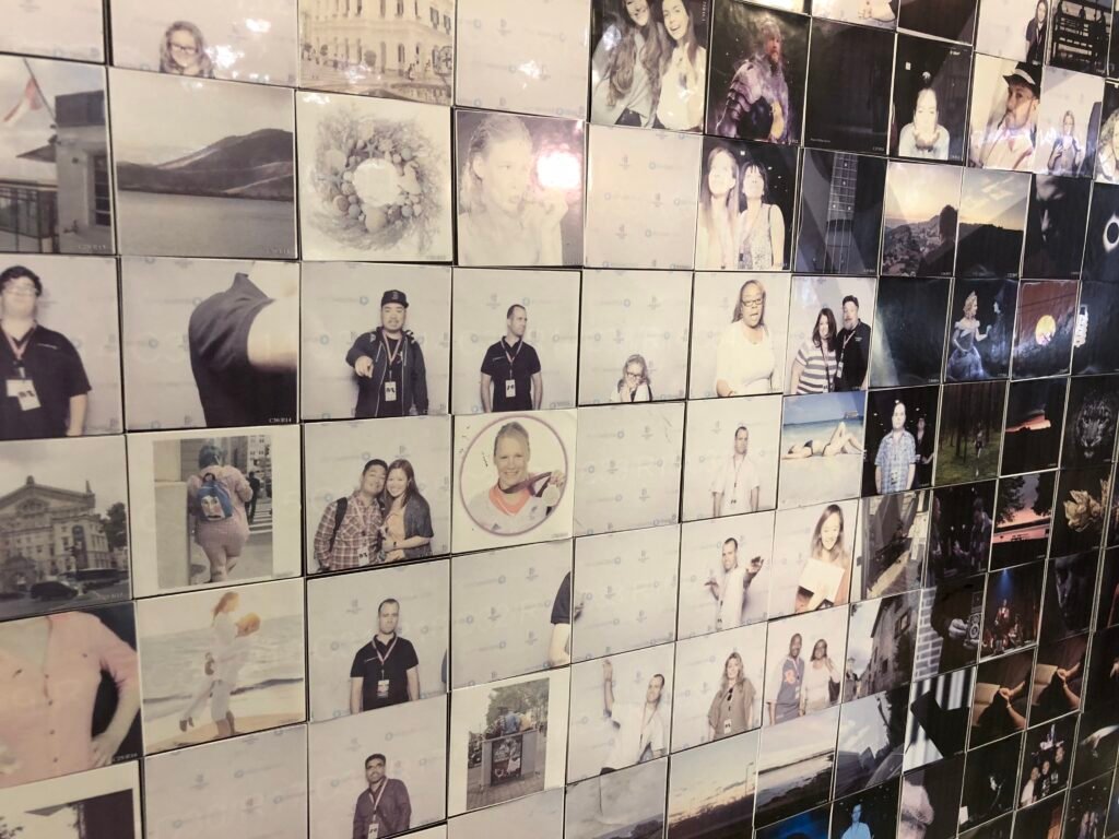 A wall covered with a collage of square photos—mostly portraits, some outdoor scenes, and a few partial images—arranged in a grid pattern, perfect for those seeking premium photo booth hire or unique graffiti wall hire experiences.
