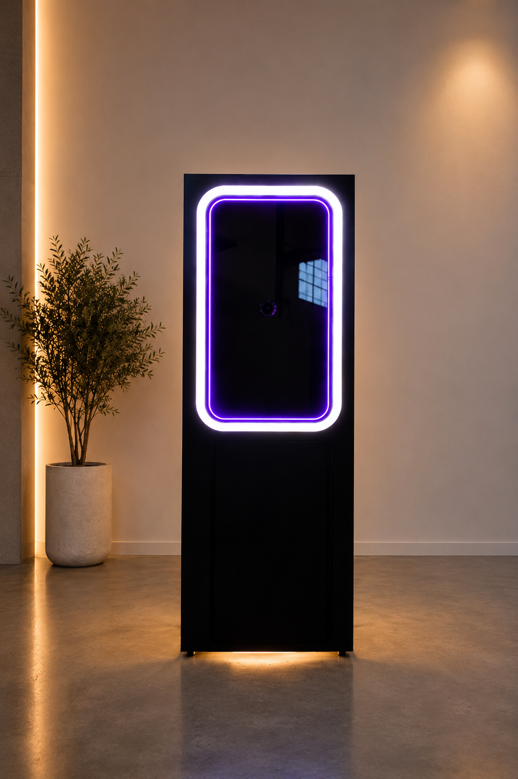 Front view of the illuminated black Scribble Booth in a modern setting.
