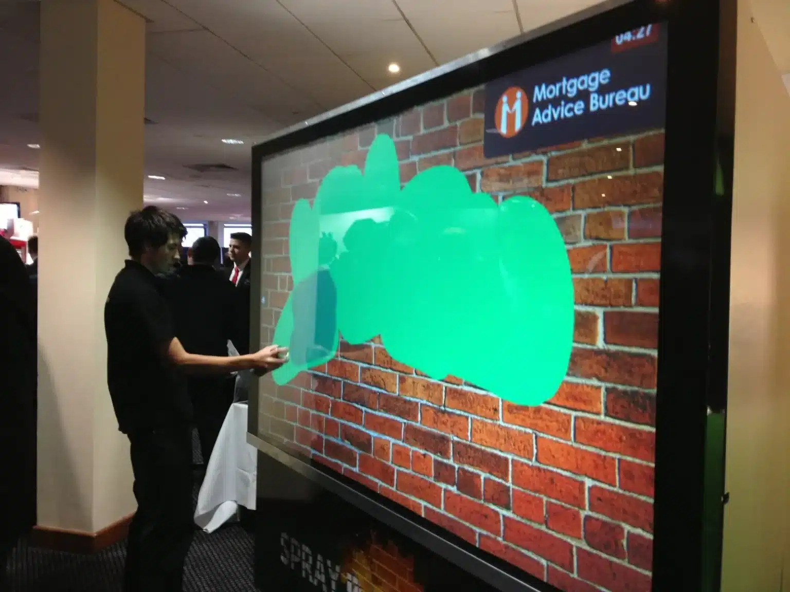 Guest using a digital spray can on a large-format AI Graffiti Wall