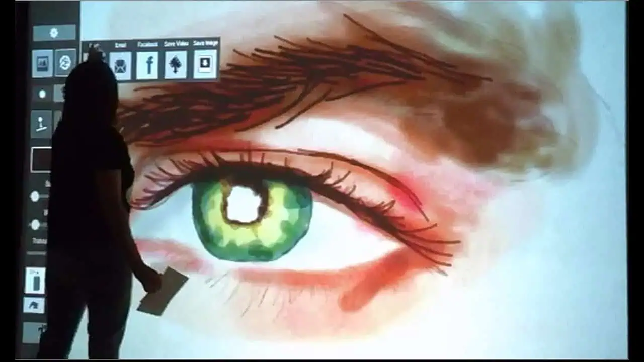 Guest viewing detailed digital eye artwork created on the AI Graffiti Wall.