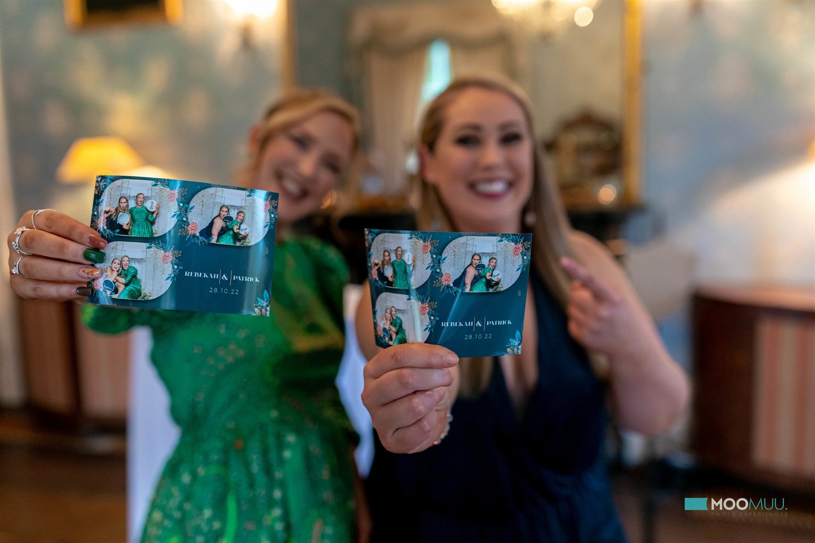 Guests holding personalised MooMuu photo booth prints