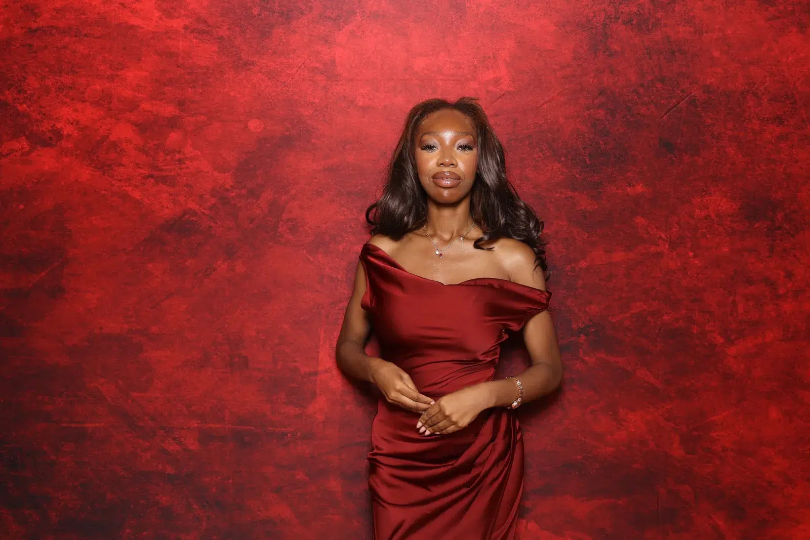 Guest portrait against a rich red event backdrop